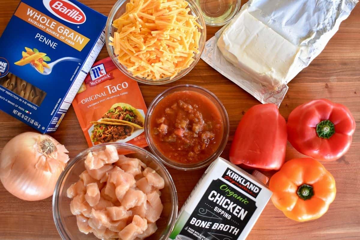 overhead photo of ingredients need to make the recipe including bell peppers, onion, broth, salsa, and cheddar cheese. 