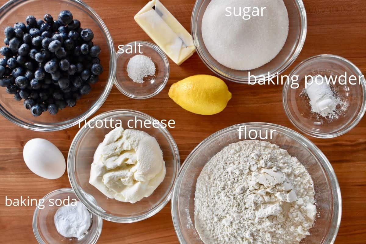 overhead photo of ingredients including flour, baking powder, butter, egg, lemon, and salt. 