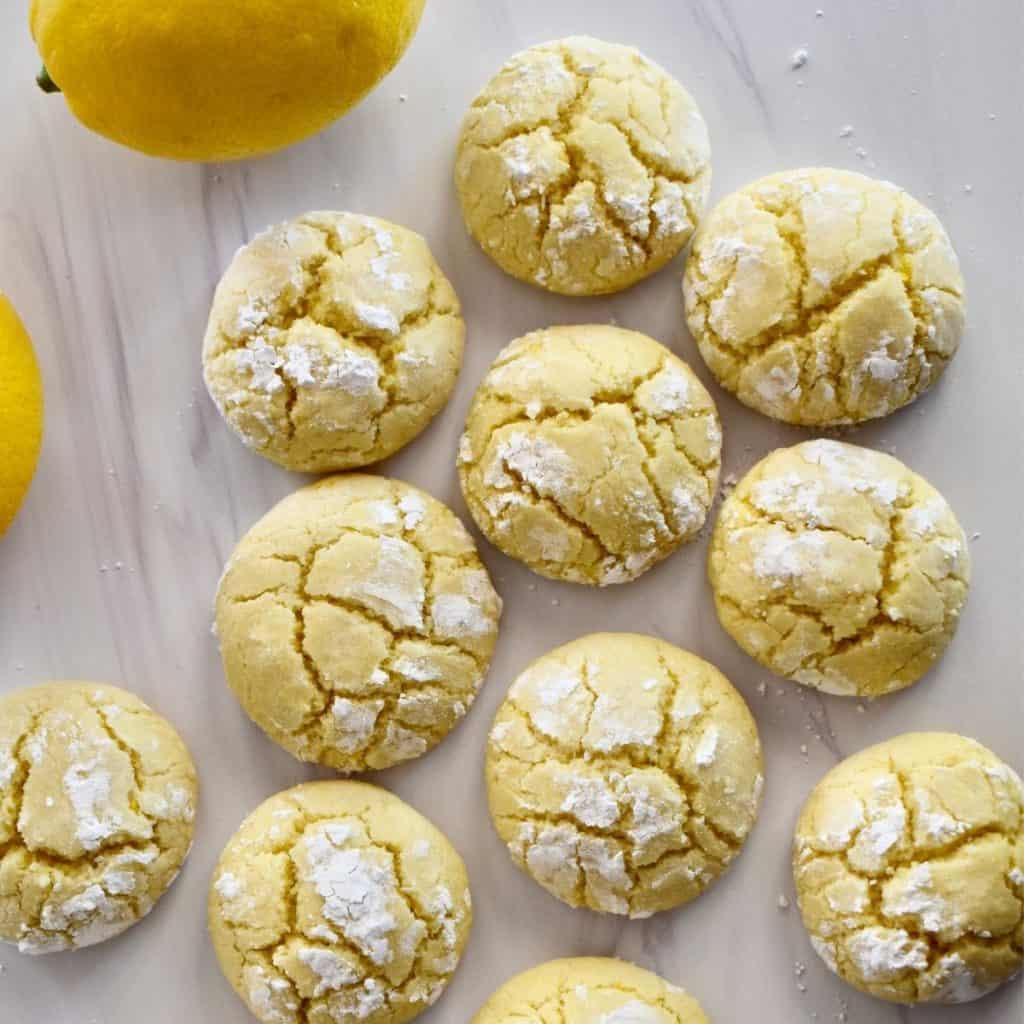 overhead photo of soft lemon cookies on a white countertop.