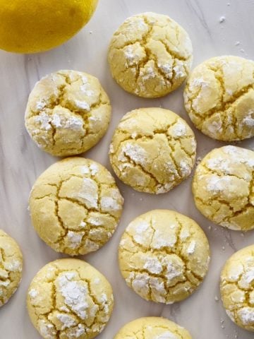 overhead photo of soft lemon cookies on a white countertop.