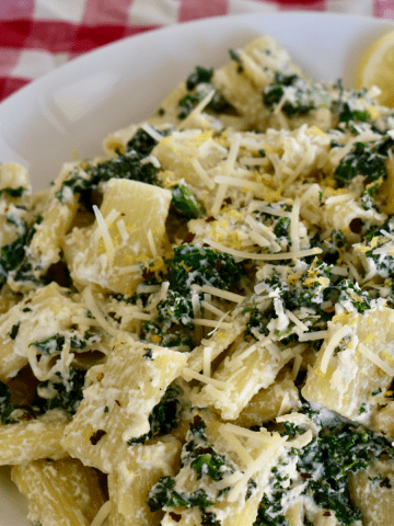 Lemon Ricotta Pasta with kale in a white bowl.