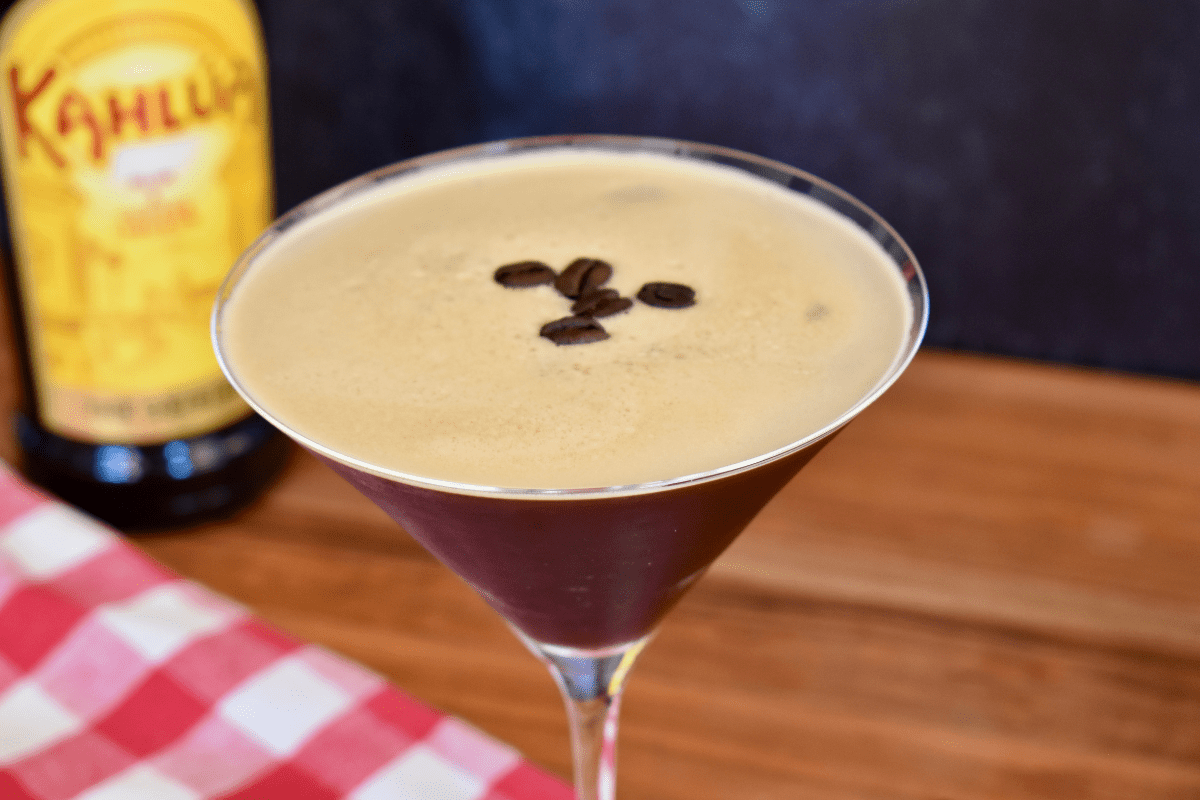 espresso martini with kahlua in a martini glass with espresso beans on top. 