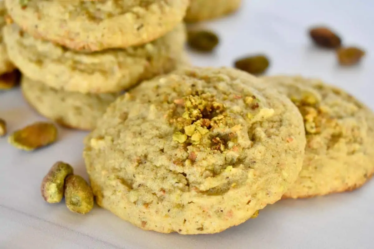 Close up of an Italian pistachio cookies with crushed pistachios on top. 