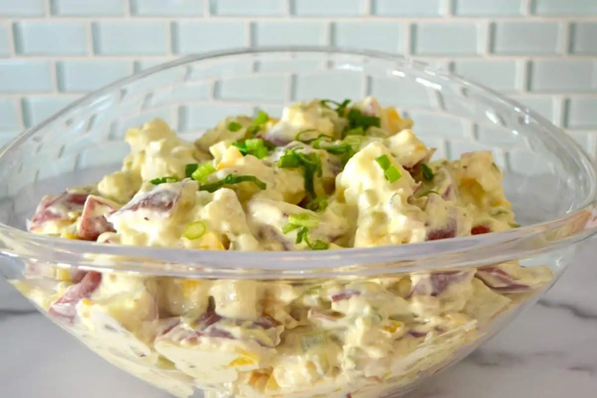 Potato Salad with Red Potatoes in a glass serving bowl. 