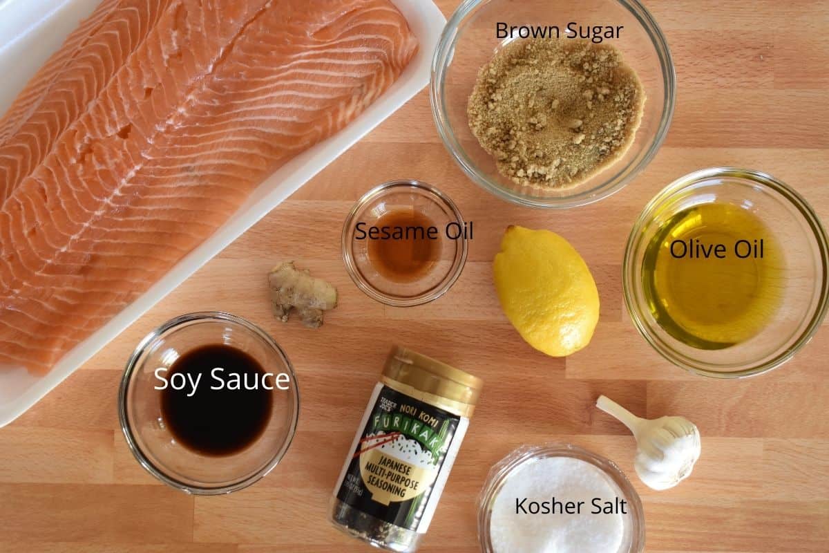 overhead photo of ingredients needed for recipe including lemon, soy sauce, ginger, and furikake seasoning.