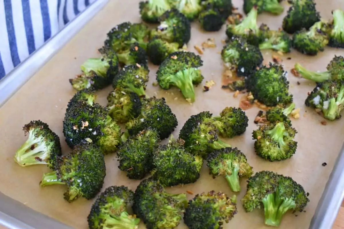 Roasted Broccoli with Garlic on a lined parchment baking pan.