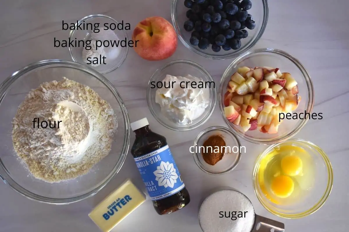 overhead photo of recipe ingredients including flour, sugar, vanilla, eggs, butter, and sour cream. 