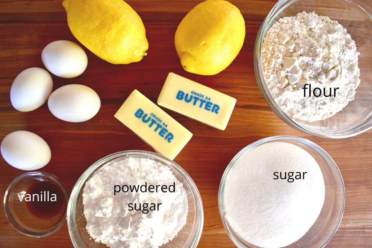 overhead photo of ingredients including butter, flour, powdered sugar, eggs, vanilla, and sugar. 