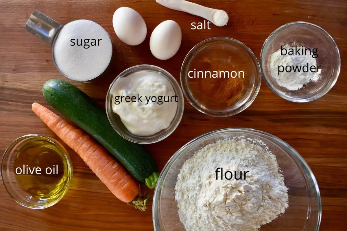 overhead photo of ingredients including flour, eggs, sugar, cinnamon, and olive oil. 