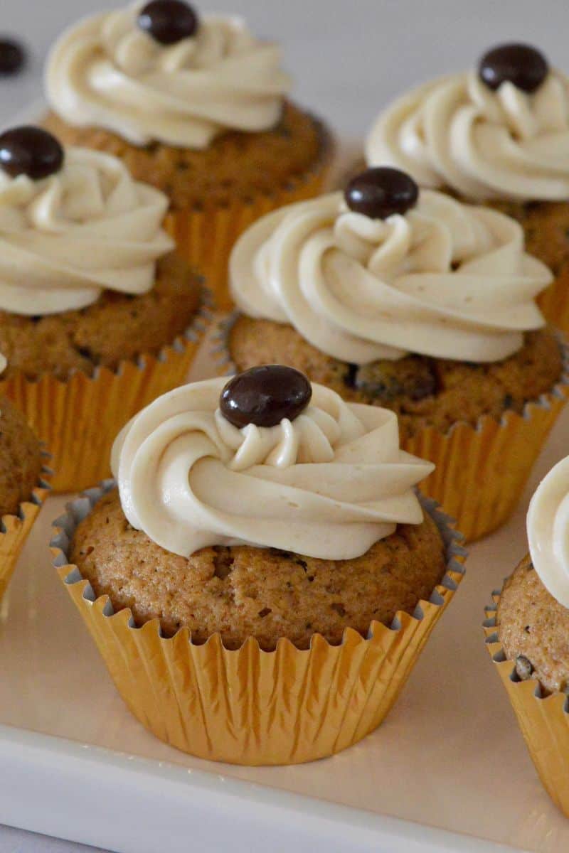 Espresso Cupcakes on a white platter with espresso cream cheese frosting on top. 
