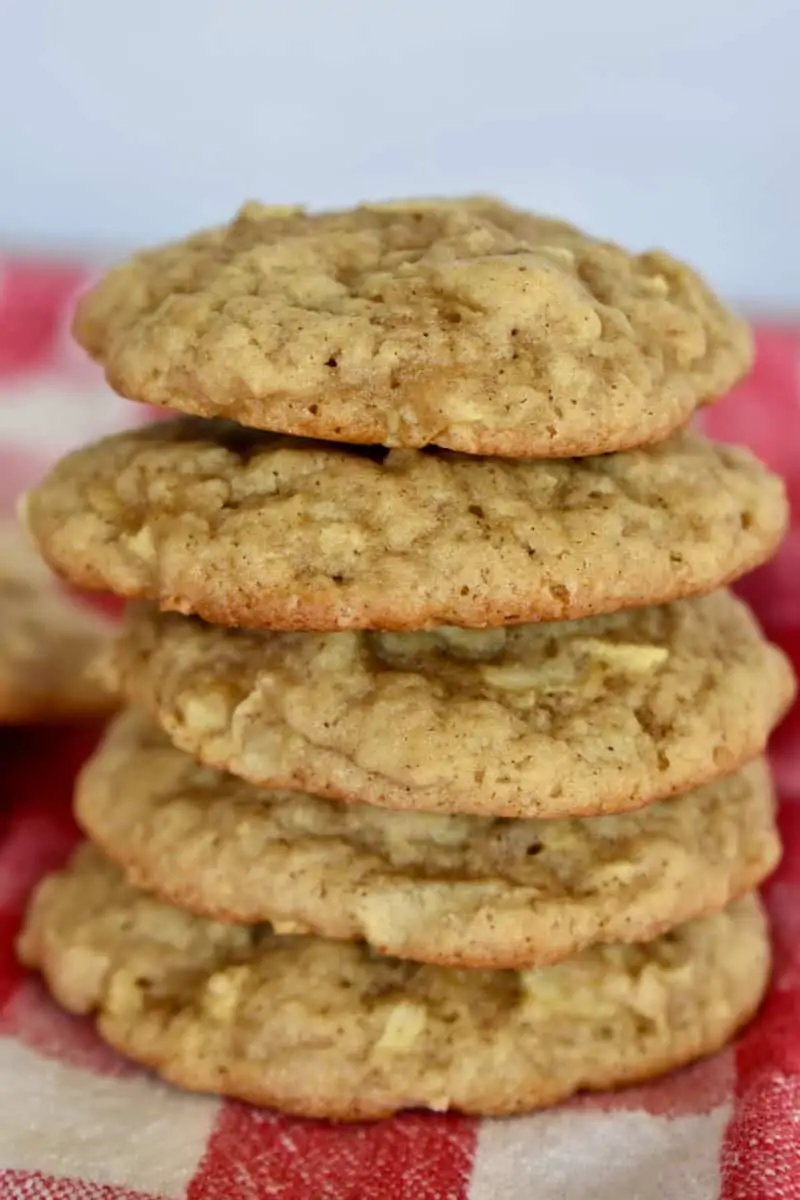 Apple Spice Cookies stacked on each other on a red and white checkered cloth. 