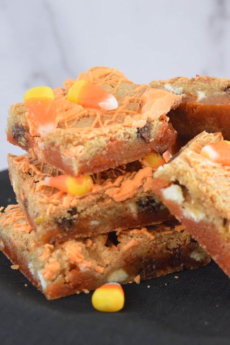 Candy Corn Blondies piled on a plate. 