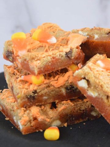 Candy Corn Blondies piled on a plate.