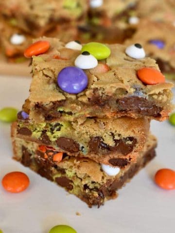 Halloween Cookie Bars with Ghouls M&M's on a countertop stacked on each other.