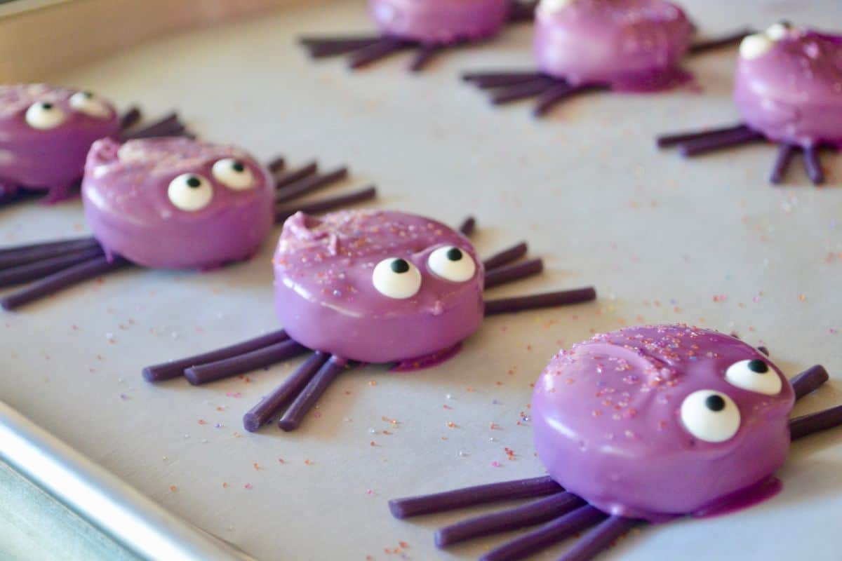 purple oreo cookie spiders on a white serving platter. 