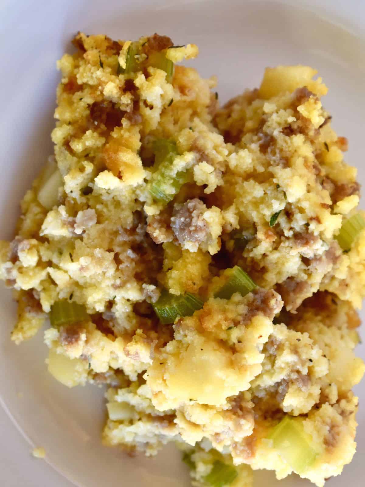 overhead photo of cornbread stuffing on a white plate. 