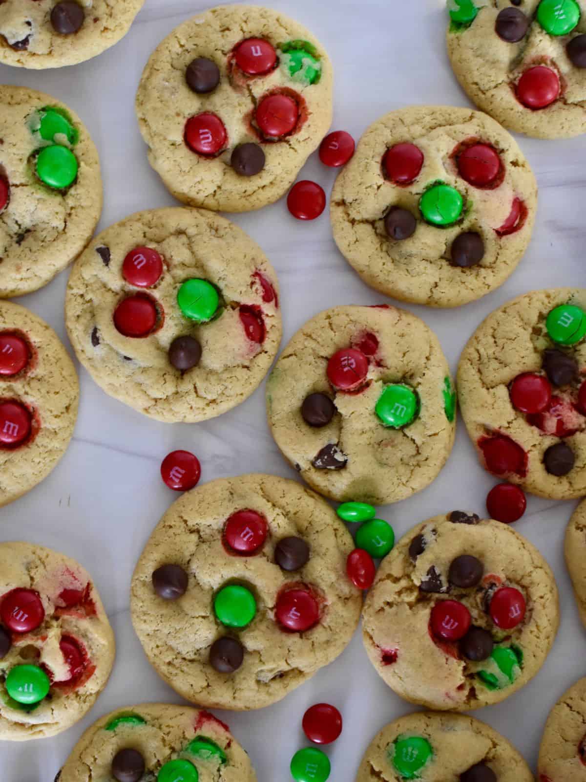 overhead photo of Christmas M&M Cookies on a white surface. 