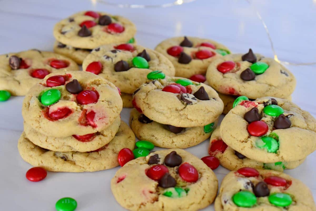 Green and red M&M cookies on a white surface. 