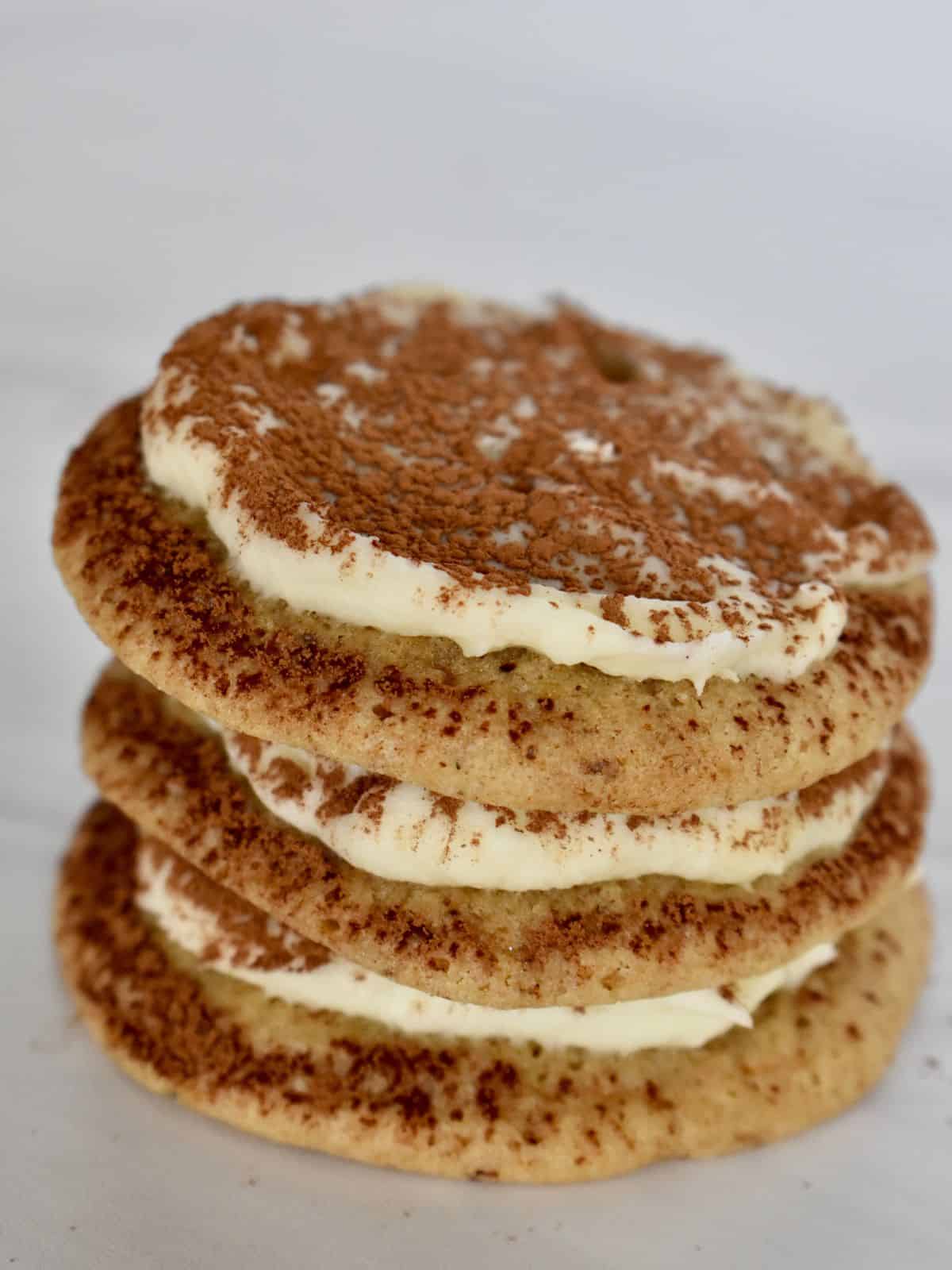 Three tiramisu cookies stacked on top of each other. 