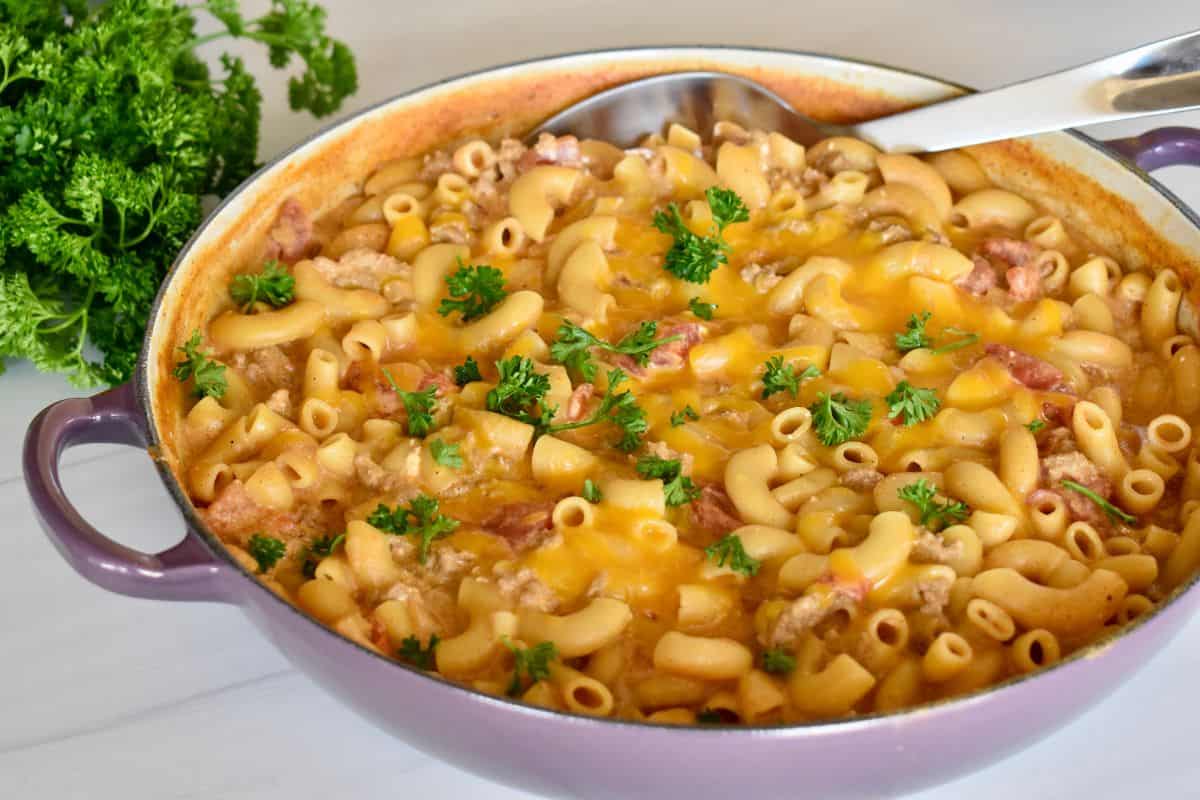 Turkey Taco Pasta in a large pan with parsley in the background. 