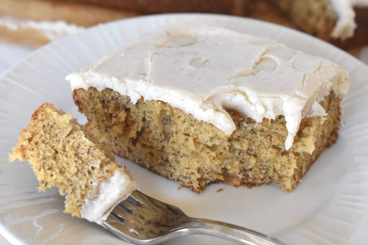Brown Butter Banana Cake on a plate with a fork. 