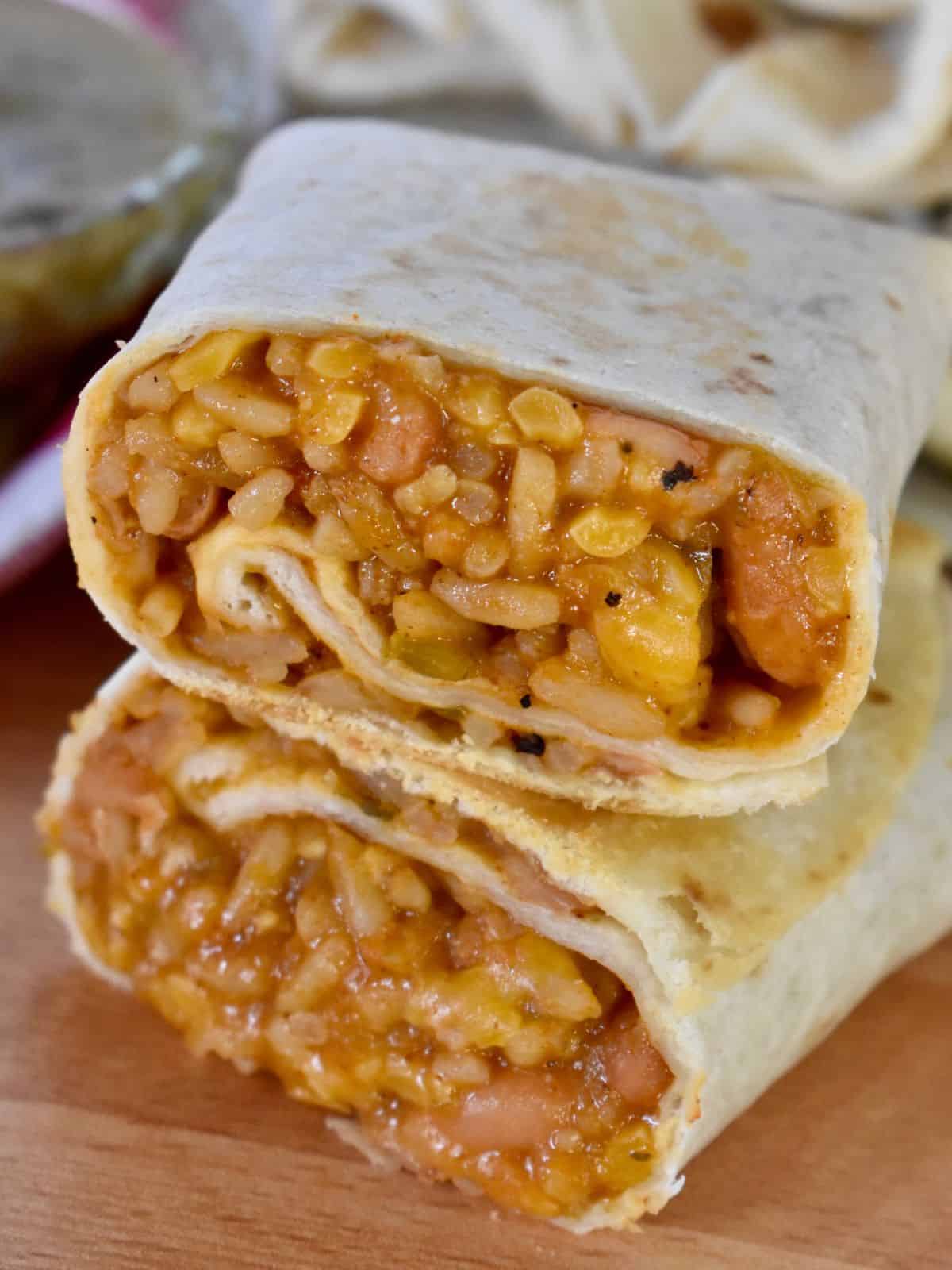 Cheesy Bean and Rice Burritos stacked on each other. 