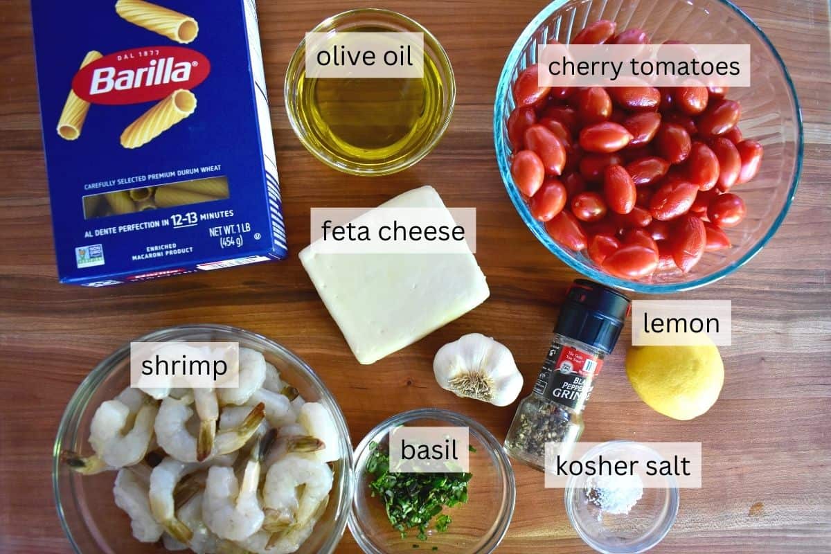 overhead photo of ingredients including tomatoes, lemon, rigatoni, and olive oil. 