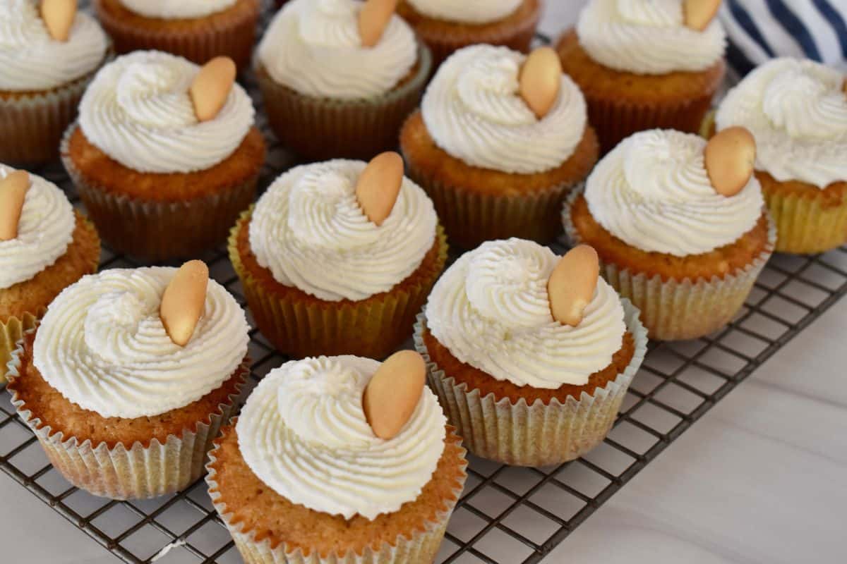 Vanilla Wafer Cupcakes with whipped cream frosting on a wire rack with a Nilla wafer on top. 