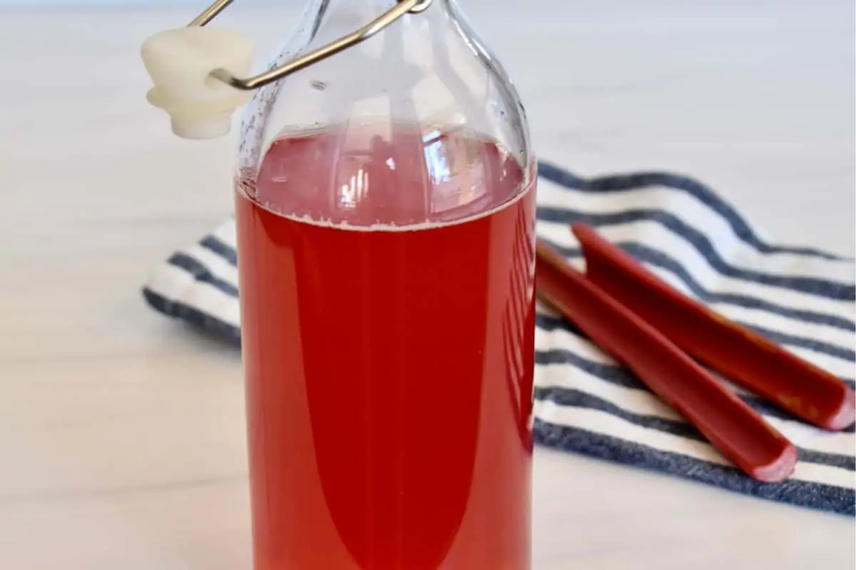 Rhubarb Simple Syrup in a glass container. 