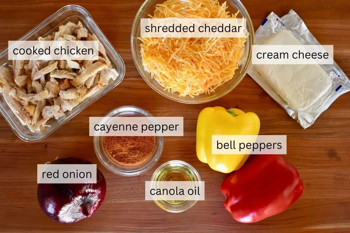 overhead photo of ingredients needed for recipe including bell peppers, onion, taco seasoning, and cream cheese. 
