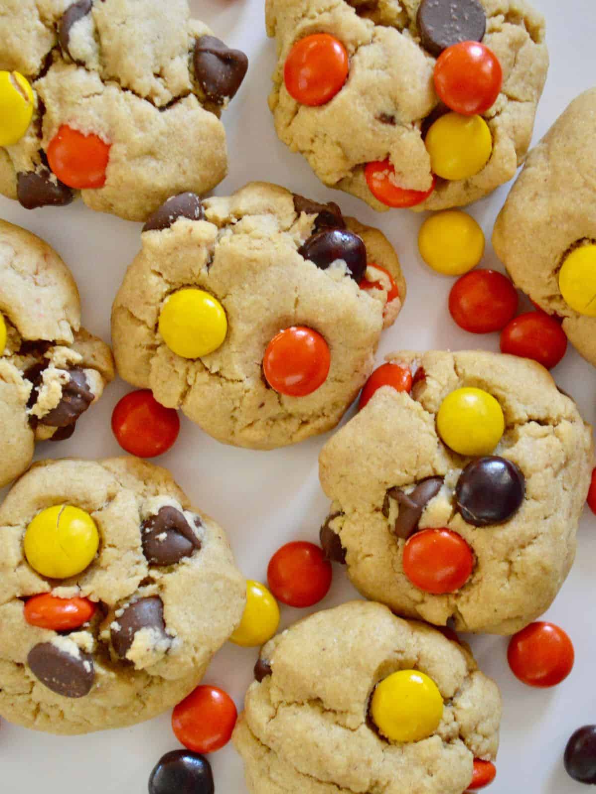 overhead photo of Reese's Pieces Peanut Butter Cookies on a white board. 