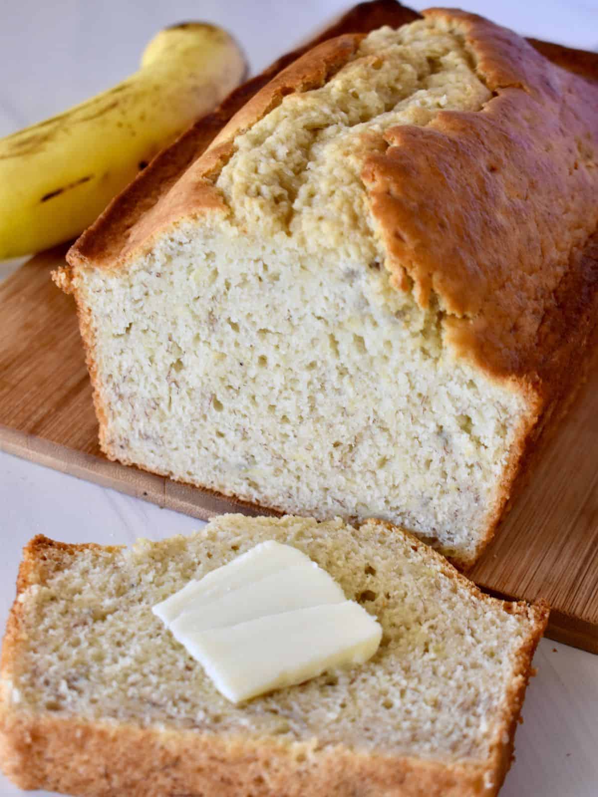 Pancake Mix Banana Bread with a pad of butter on a countertop. 