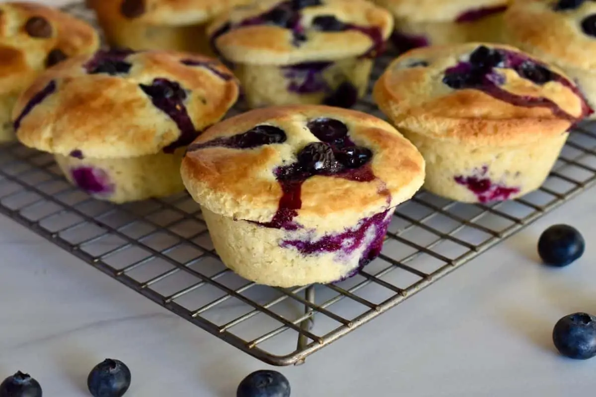 blueberry pancake mix muffins cooling on a wire rack. 