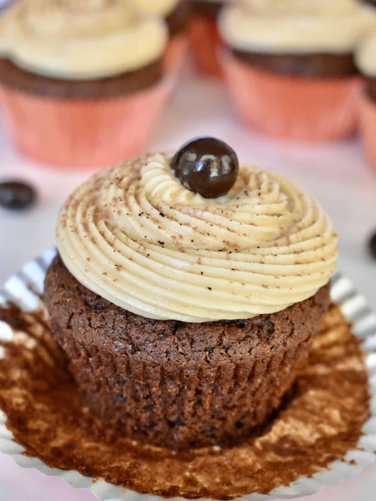 Espresso cupcakes on with coffee cream cheese frosting and a chocolate covered espresso bean on top. 