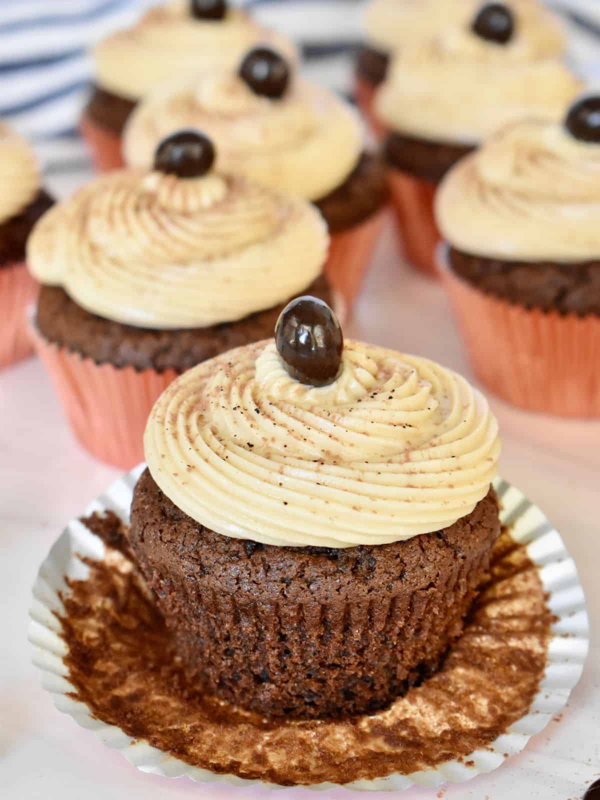 Espresso cupcakes with espresso cream cheese frosting on a countertop. 