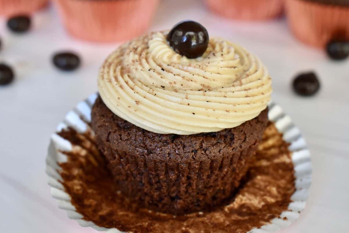 Espresso cupcake on a counter with cupcake liner pulled down.