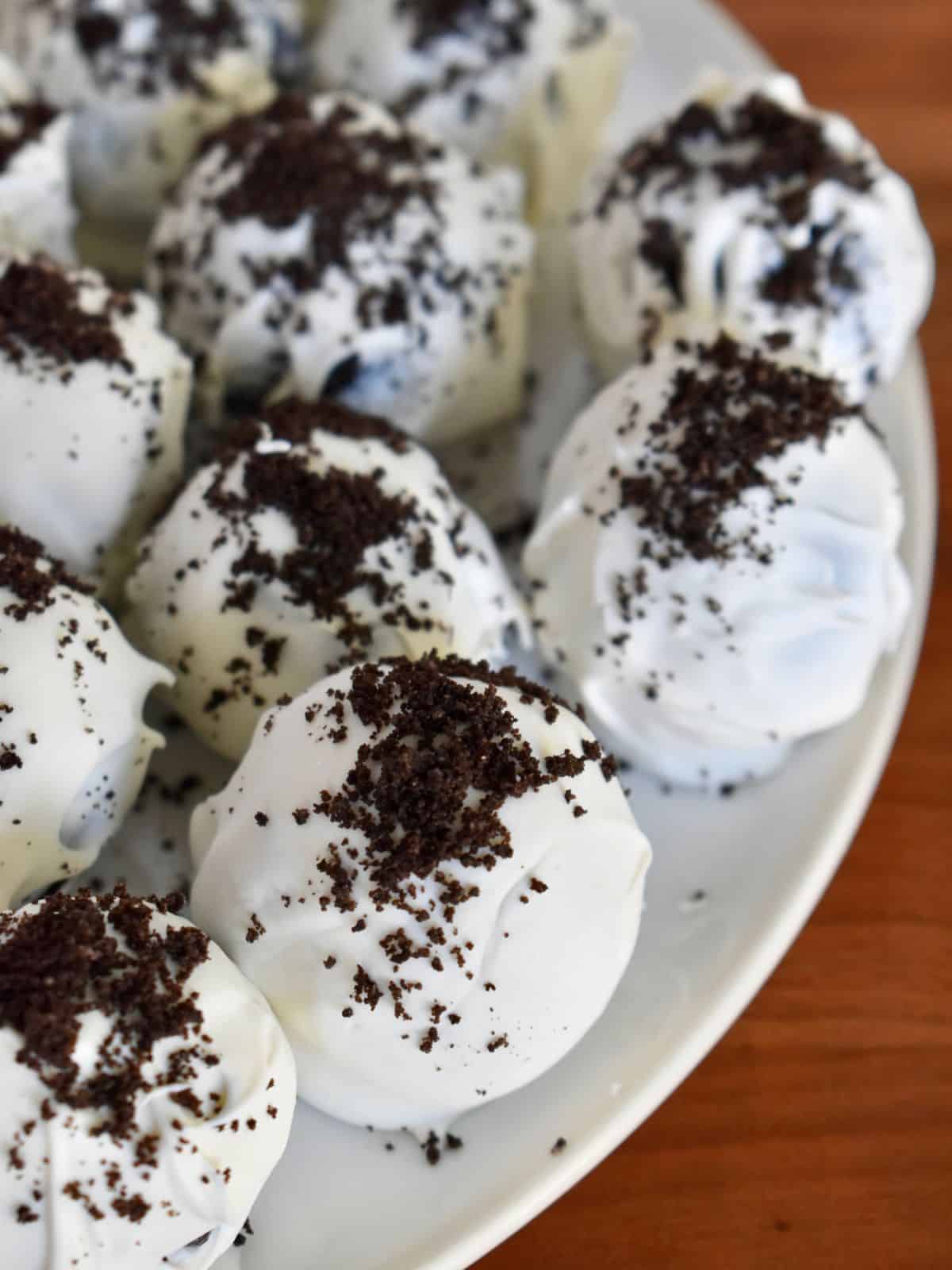Cookies and Cream Truffles on a white plate. 