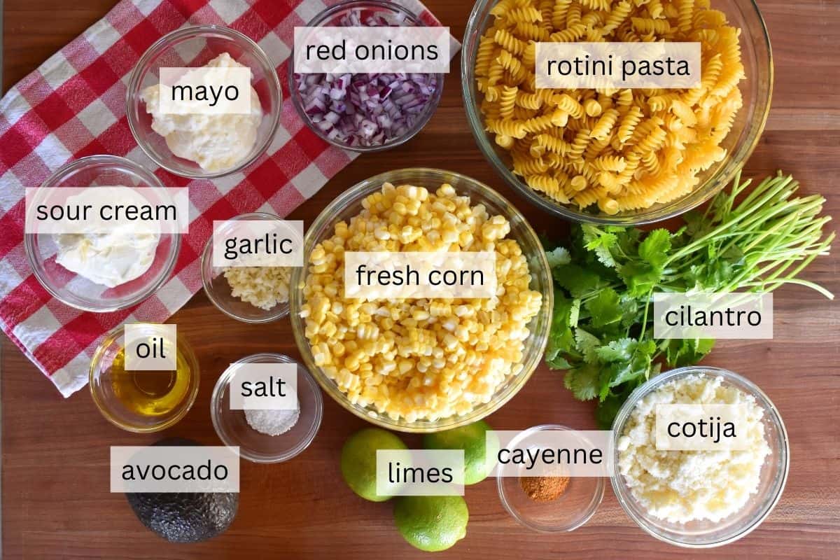Ingredients for recipe including corn, cotija cheese, rotini, avocado, and cilantro. 