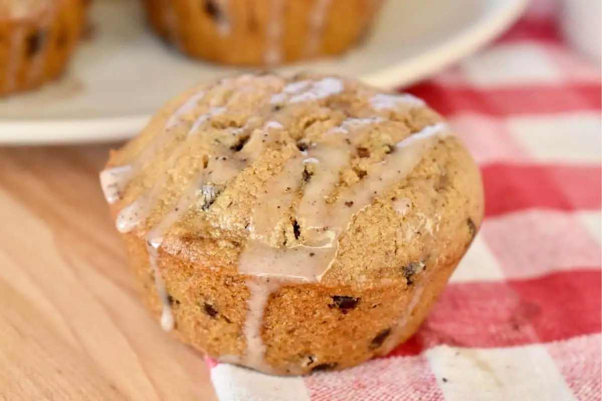 Cappuccino muffins with espresso glaze on a checkered napkin. 