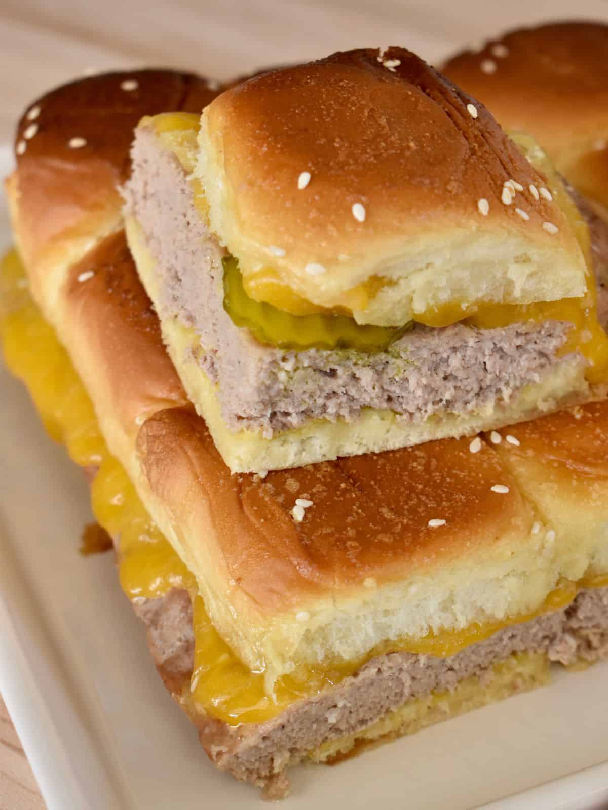 Turkey Burger Sliders on a white serving tray stacked on each other. 