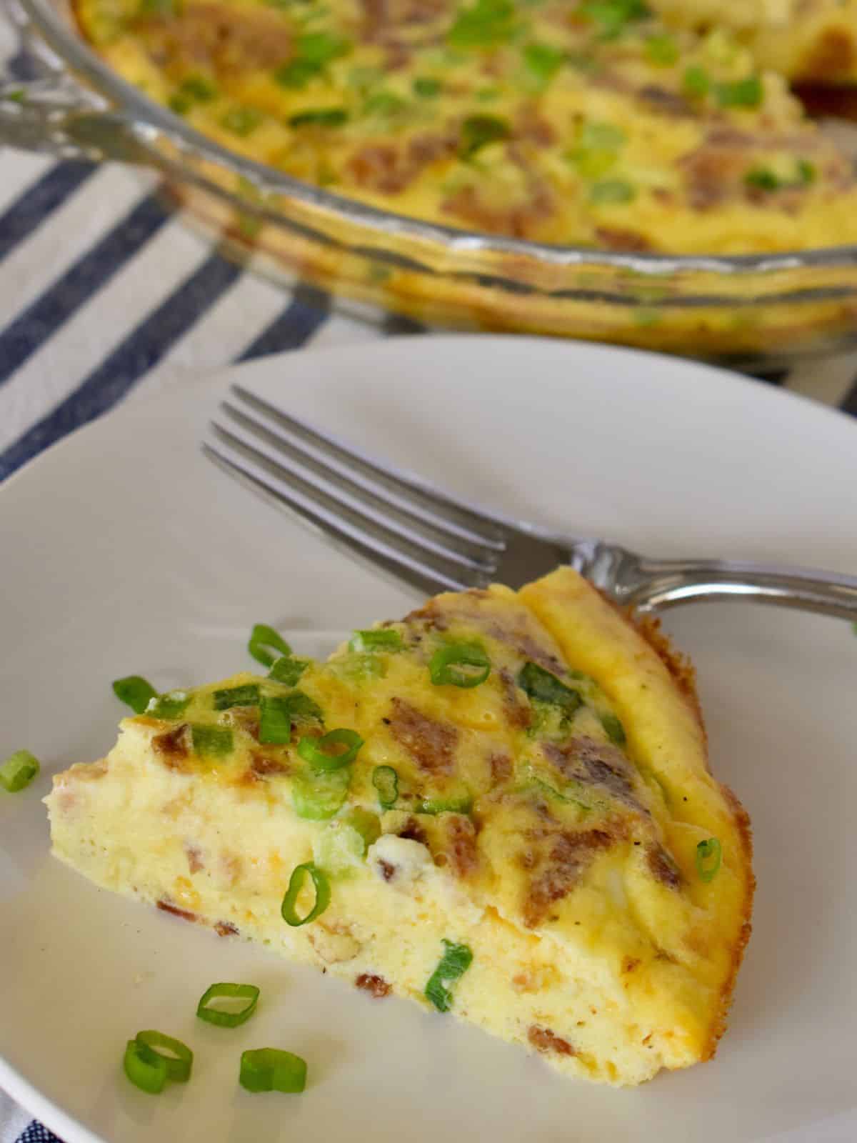 Crustless Ricotta Quiche on a white plate with a fork. 