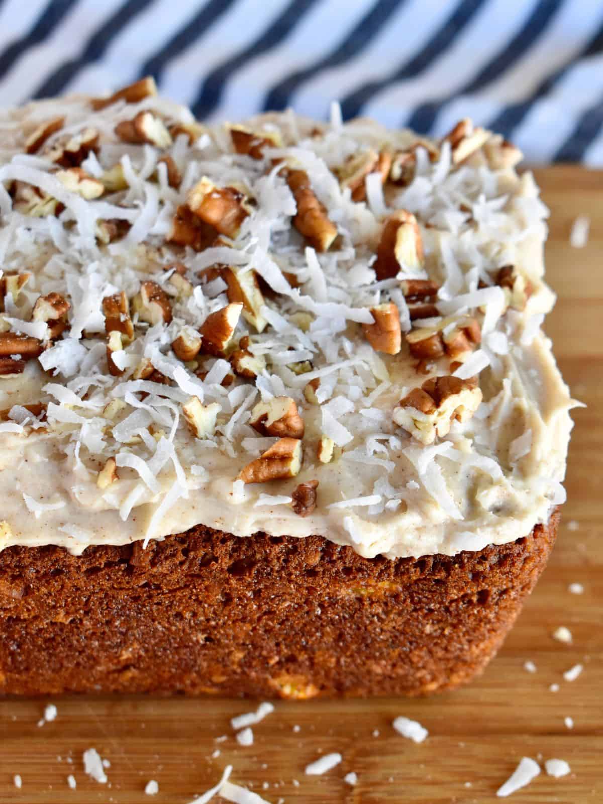 Frosted Hummingbird Bread with pecans and coconut on top. 