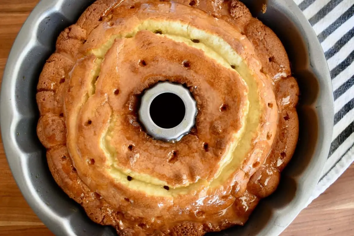 Amaretto Pound Cake with holes poked into it and hot amaretto butter glaze poured on top. 