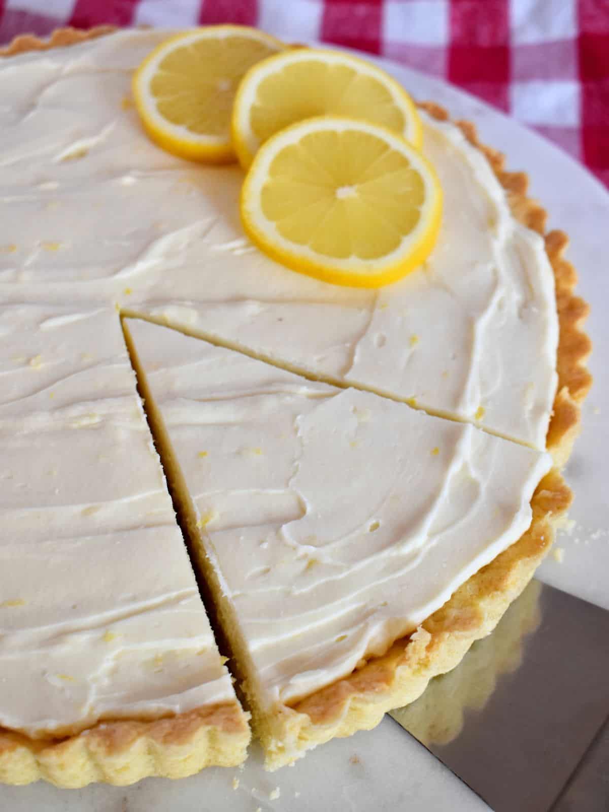 Lemon Mascarpone Tart with a slice cut into it. 