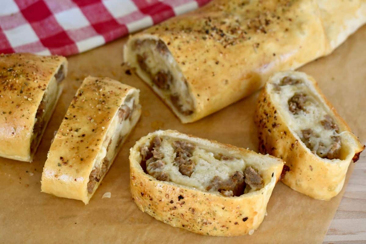 Italian Sausage Bread sliced on a cutting board.