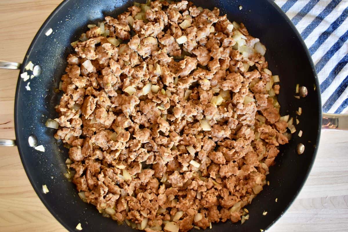 Ground meat and onion browned in a large skillet. 