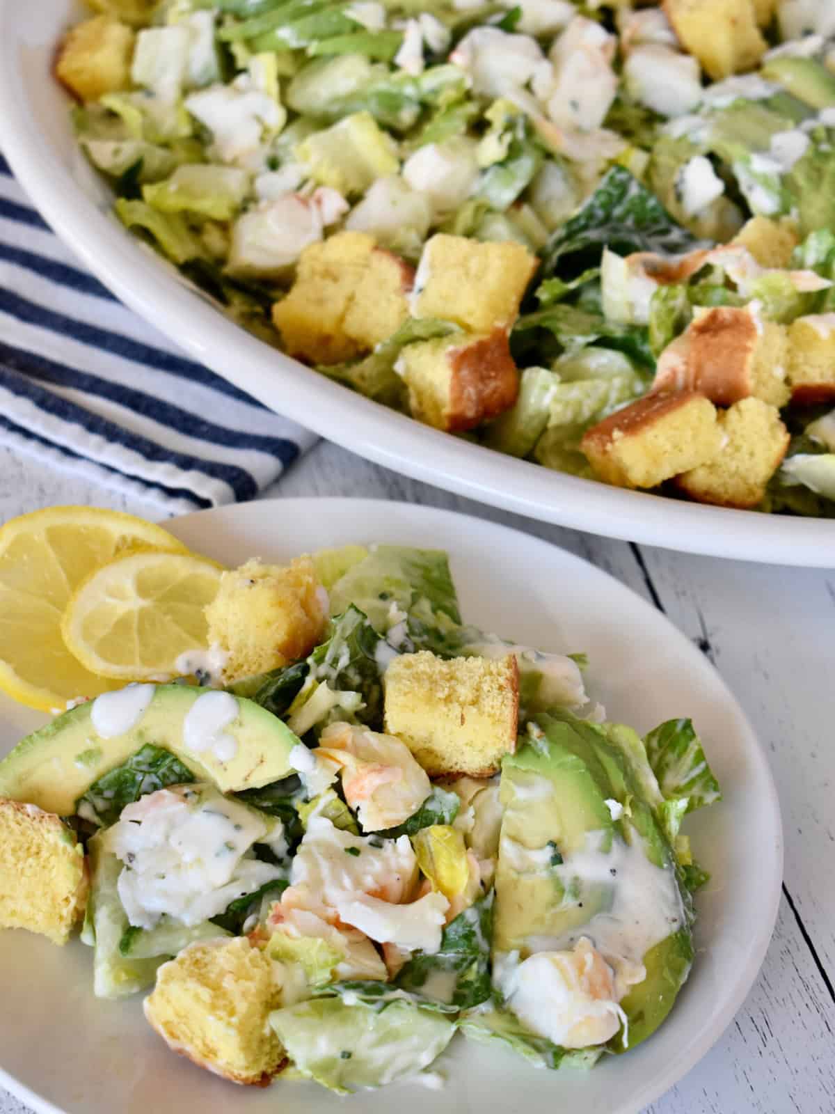 Lobster Roll Salad on a serving plate with brioche croutons.