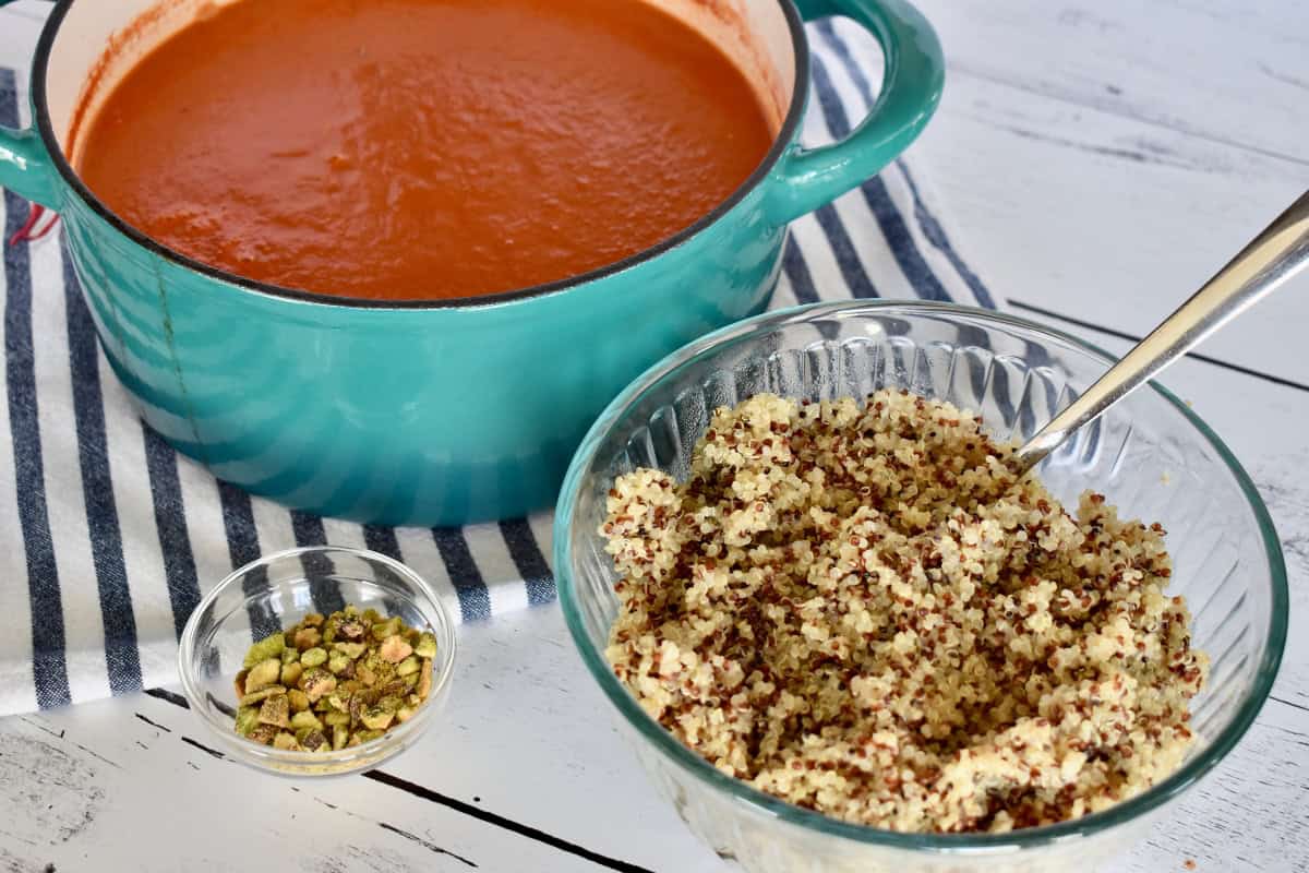 Bowl of quinoa, tomato soup, and pistachios. 