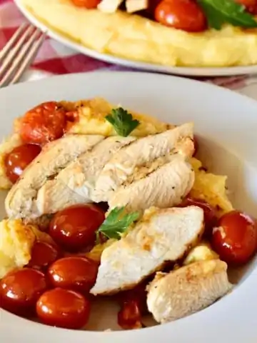 Chicken with Polenta and cherry tomatoes.