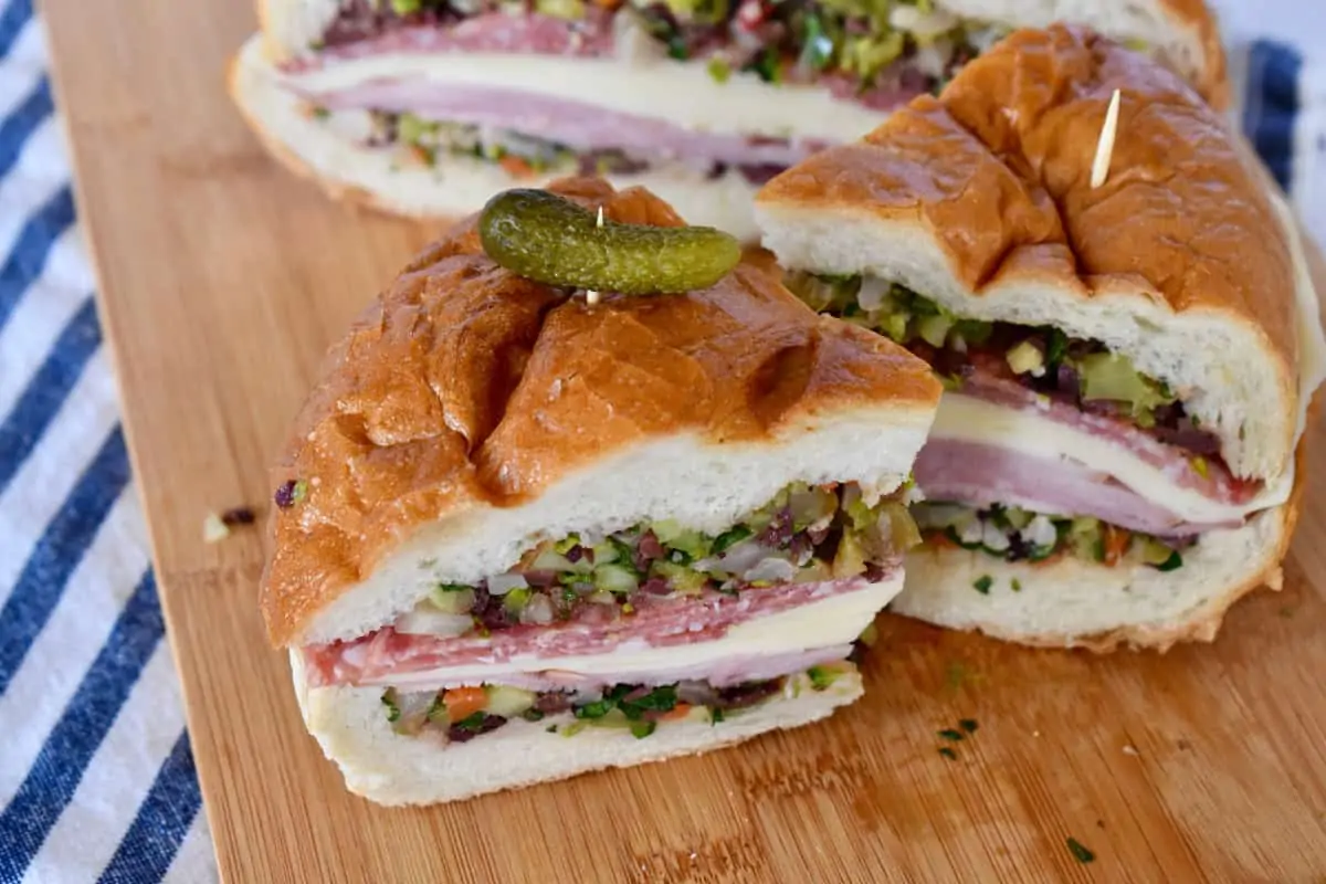 Muffuletta sandwich on a cutting board. 